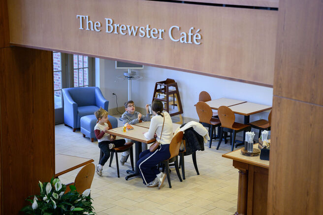 Family enjoying snacks, sign overhead reads 